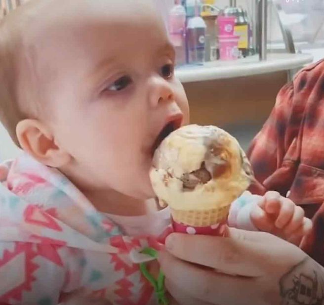 Después de dar su primer lametazo al helado, el bebé se sorprende.